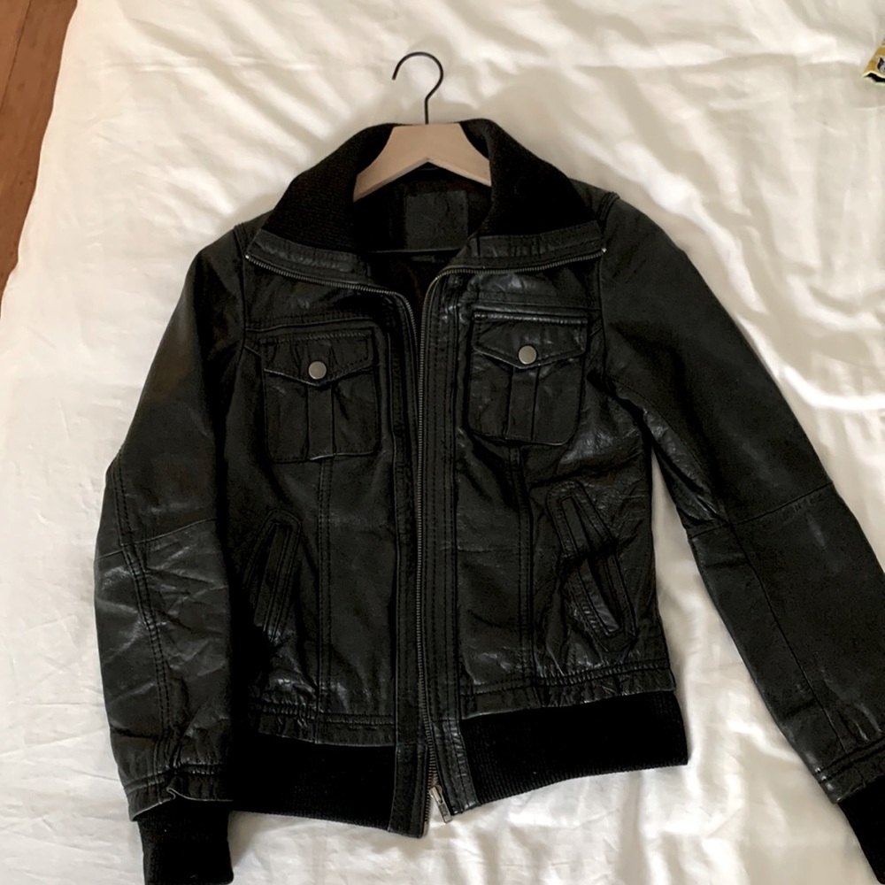 Beautiful 100% black leather jacket. Size Small. Ribbed ends. Zipper, 4 pockets